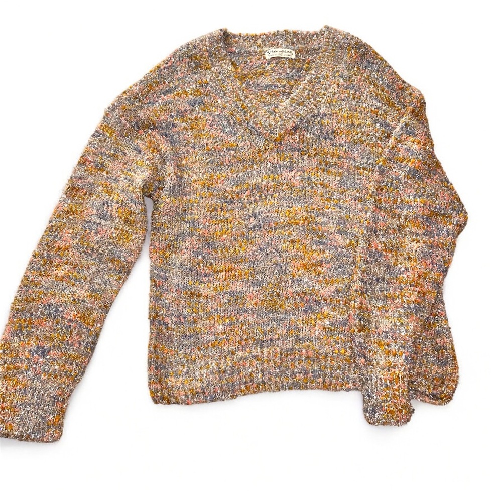 Soft and cozy pastel pink, blue and yellow sweater  with silver tinsel.